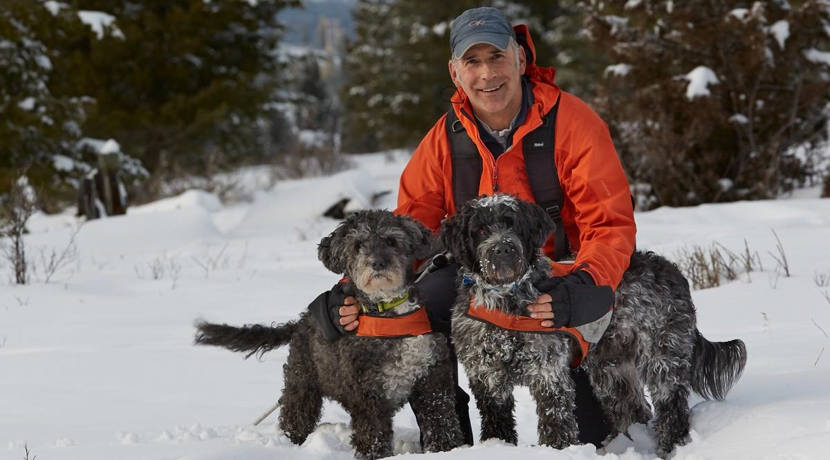 Brad Hill, photographer, with his dogs in the snow.