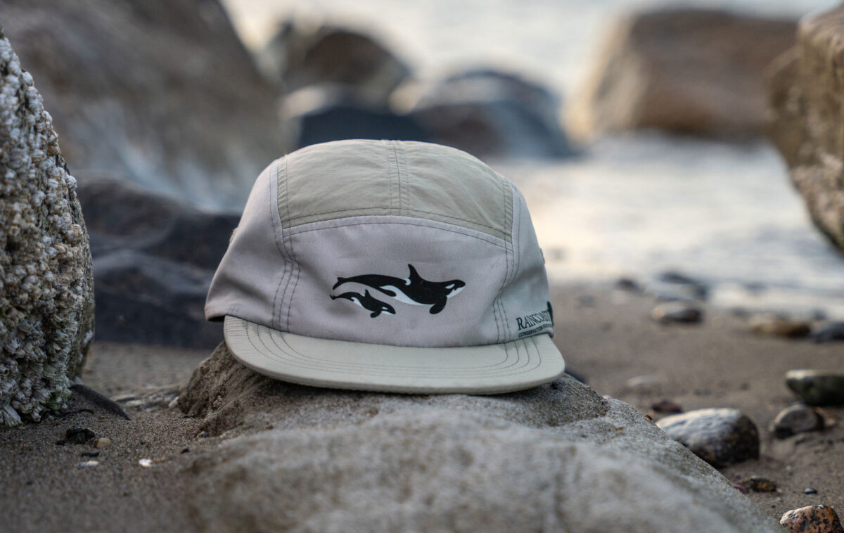 A light active gear hat with Raincoast logo and killer whales.